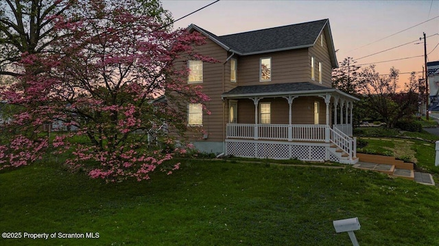 316 Sibley Ave, Old Forge, PA 18518 - view of front facade featuring a porch, a shingled roof, and a front lawn