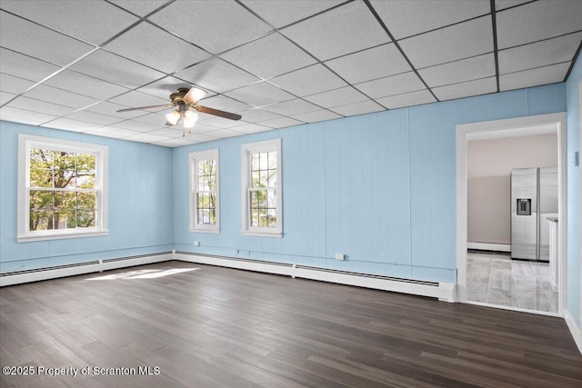 316 Sibley Ave, Old Forge, PA 18518 - unfurnished room with wood finished floors, healthy amount of natural light, ceiling fan, a paneled ceiling, and a baseboard heating unit