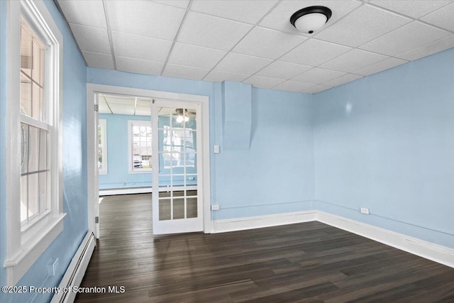 316 Sibley Ave, Old Forge, PA 18518 - empty room featuring wood finished floors, a baseboard radiator, a paneled ceiling, and baseboards