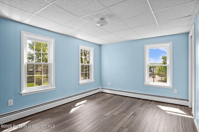 316 Sibley Ave, Old Forge, PA 18518 - unfurnished room with wood finished floors, a paneled ceiling, a baseboard radiator, healthy amount of natural light, and baseboards