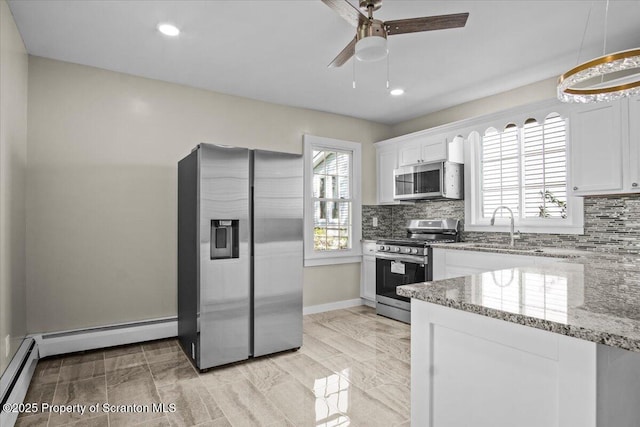 316 Sibley Ave, Old Forge, PA 18518 - kitchen with stainless steel appliances, tasteful backsplash, light stone countertops, white cabinets, and recessed lighting
