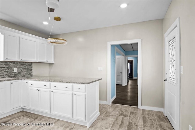 316 Sibley Ave, Old Forge, PA 18518 - kitchen featuring white cabinetry, light stone counters, decorative backsplash, baseboards, and recessed lighting
