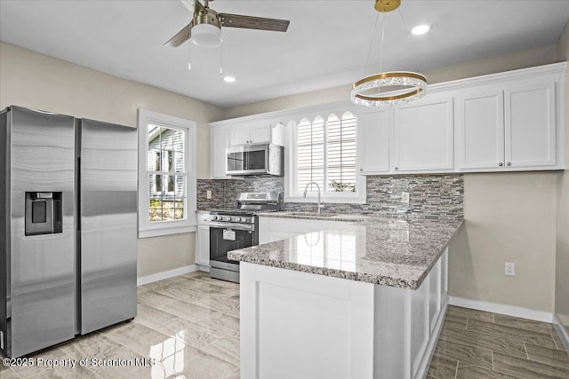 316 Sibley Ave, Old Forge, PA 18518 - kitchen with stainless steel appliances, a peninsula, white cabinets, baseboards, and recessed lighting