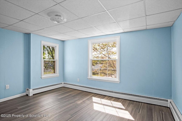 316 Sibley Ave, Old Forge, PA 18518 - unfurnished room with a baseboard heating unit, wood finished floors, a drop ceiling, and baseboards