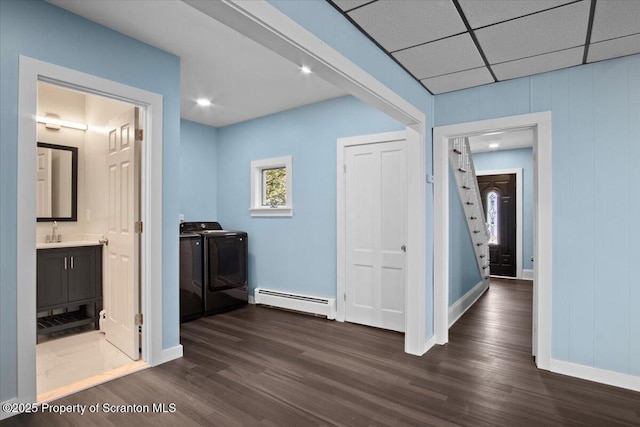 316 Sibley Ave, Old Forge, PA 18518 - corridor with a baseboard radiator, washing machine and clothes dryer, dark wood-type flooring, and baseboards