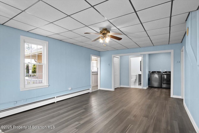 316 Sibley Ave, Old Forge, PA 18518 - unfurnished living room with a baseboard heating unit, separate washer and dryer, wood finished floors, healthy amount of natural light, and a drop ceiling