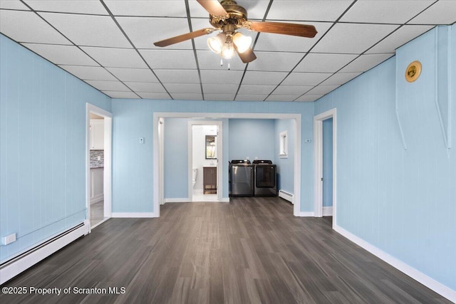 316 Sibley Ave, Old Forge, PA 18518 - unfurnished living room with washer and dryer, a baseboard radiator, dark wood-style flooring, a ceiling fan, and a drop ceiling
