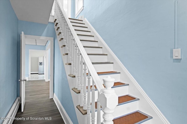 316 Sibley Ave, Old Forge, PA 18518 - stairs featuring a baseboard radiator, wood finished floors, baseboards, a baseboard heating unit, and attic access