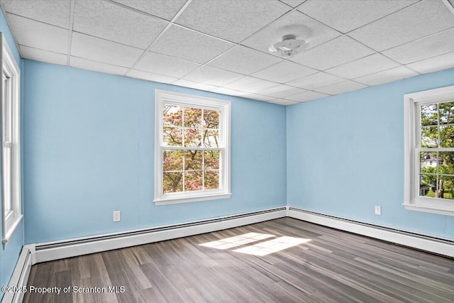 316 Sibley Ave, Old Forge, PA 18518 - unfurnished room featuring wood finished floors, a baseboard radiator, baseboards, and a drop ceiling