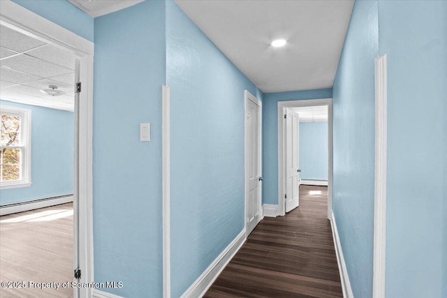 316 Sibley Ave, Old Forge, PA 18518 - hallway featuring a baseboard radiator, a baseboard heating unit, dark wood-style flooring, and baseboards