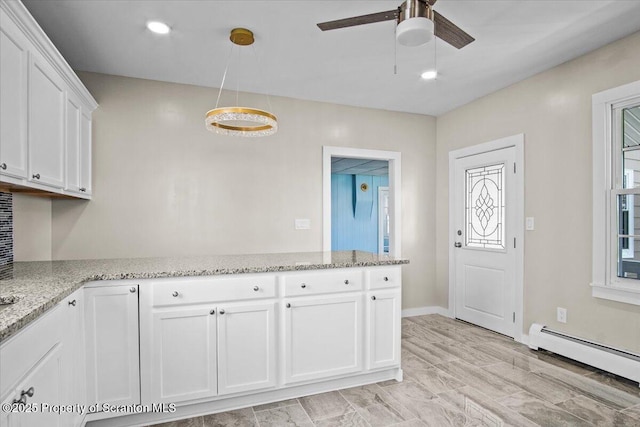 316 Sibley Ave, Old Forge, PA 18518 - kitchen featuring a baseboard heating unit, ceiling fan, white cabinetry, light stone counters, and a peninsula