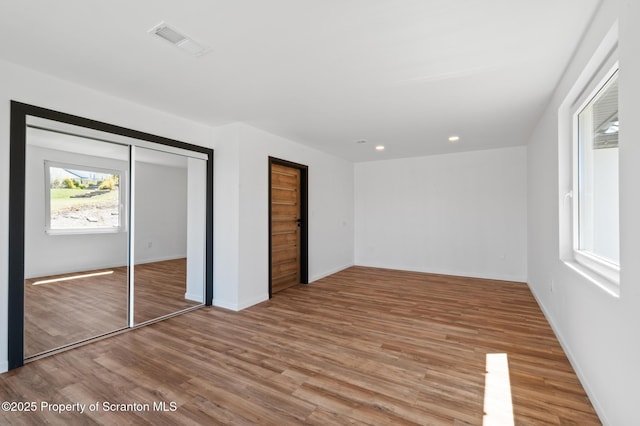 203 Red Oak Dr, Olyphant, PA 18447 - unfurnished bedroom featuring a closet, baseboards, recessed lighting, visible vents, and wood finished floors