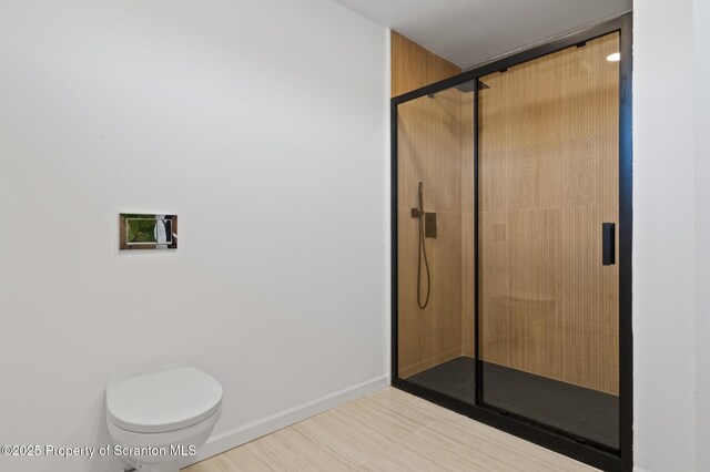 203 Red Oak Dr, Olyphant, PA 18447 - bathroom featuring toilet, a stall shower, and baseboards