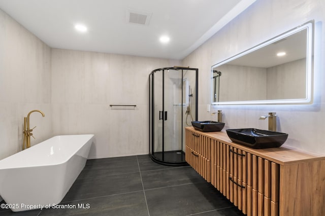 203 Red Oak Dr, Olyphant, PA 18447 - bathroom featuring a sink, double vanity, a freestanding tub, and a stall shower