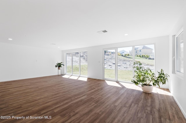 203 Red Oak Dr, Olyphant, PA 18447 - unfurnished living room with dark wood-type flooring, baseboards, and visible vents
