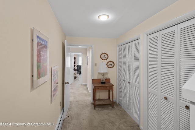 corridor featuring light colored carpet