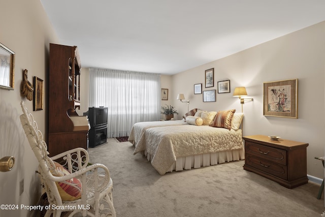 bedroom featuring light colored carpet