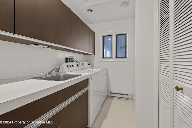 washroom with independent washer and dryer, cabinets, a baseboard radiator, and sink