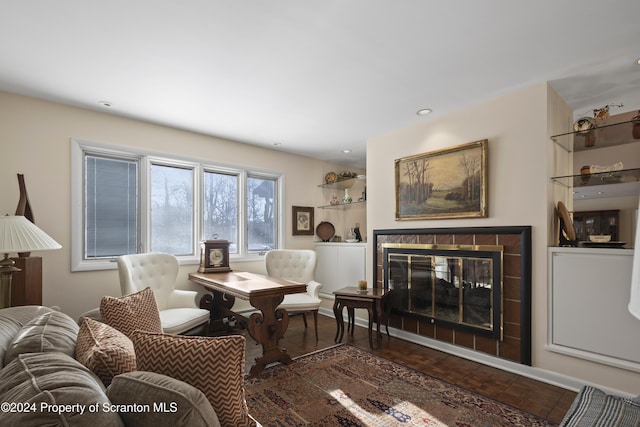 living room with a tile fireplace