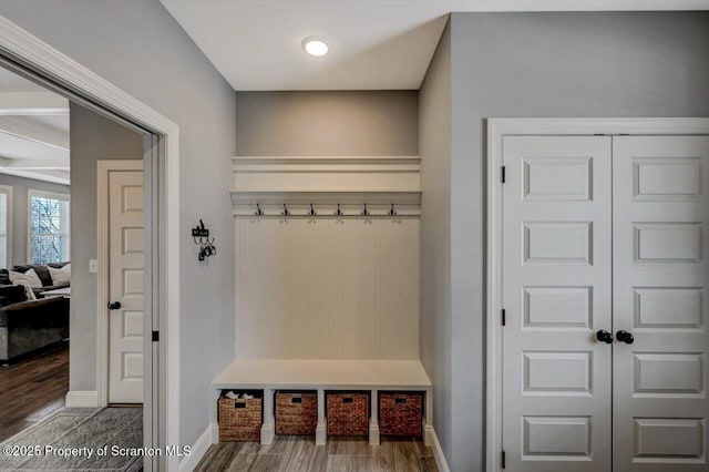 mudroom with wood finished floors and baseboards