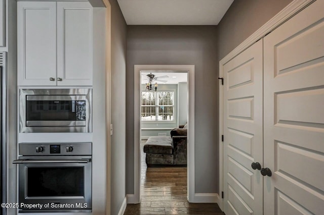 interior space featuring dark wood-style floors and baseboards