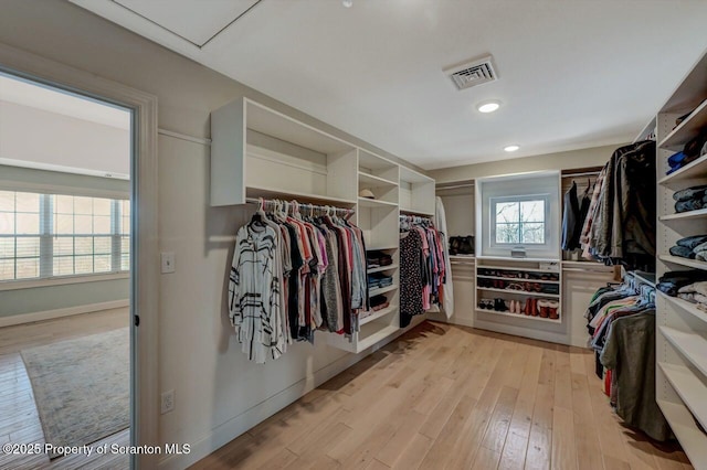 spacious closet with light wood finished floors and visible vents