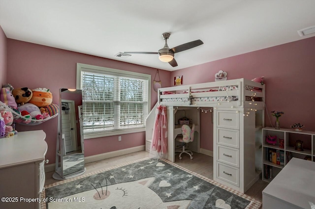 bedroom featuring baseboards, visible vents, ceiling fan, and wood finished floors