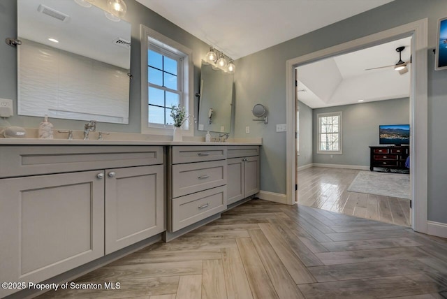 full bathroom featuring double vanity, a sink, visible vents, and baseboards