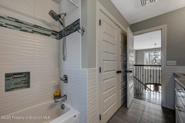 full bathroom with washtub / shower combination, visible vents, a notable chandelier, and tile patterned floors