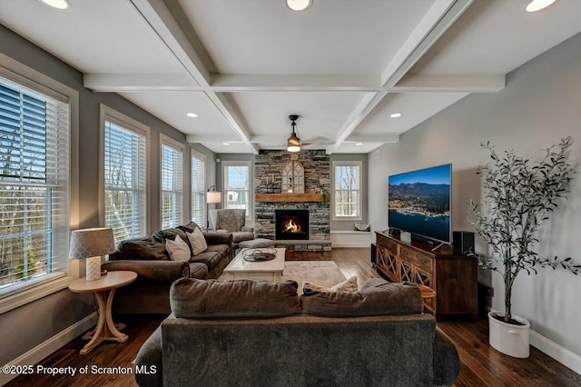 living area featuring coffered ceiling, beamed ceiling, baseboards, and wood finished floors