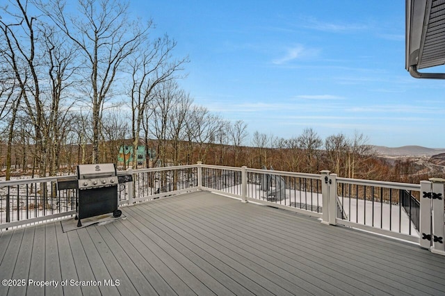 wooden deck featuring area for grilling and a mountain view