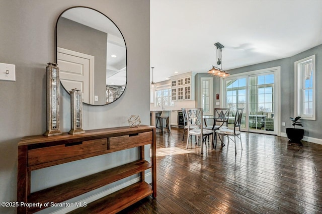 hall with recessed lighting, wood-type flooring, and baseboards