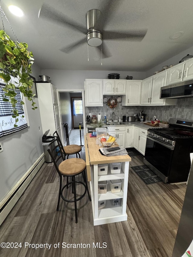 kitchen featuring decorative backsplash, sink, white cabinets, and appliances with stainless steel finishes