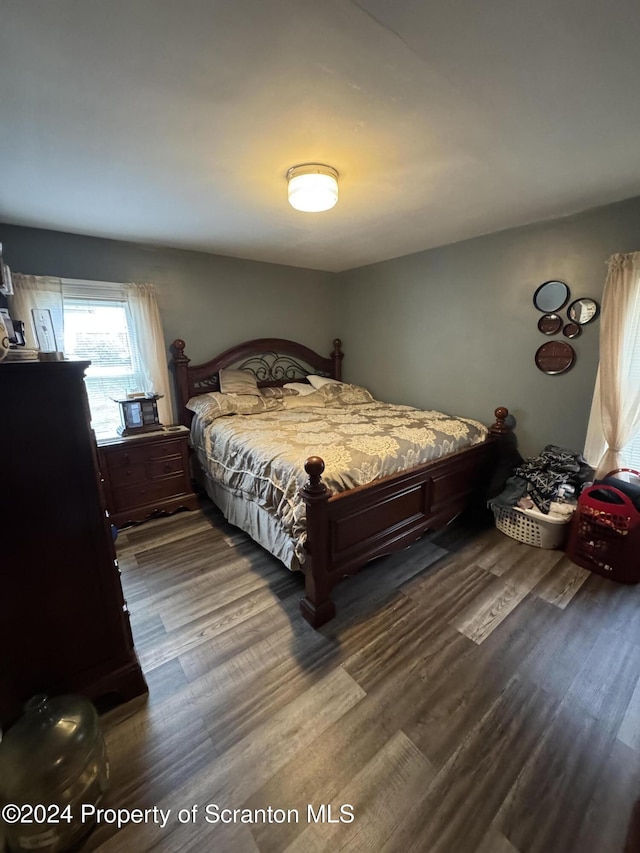 bedroom featuring dark hardwood / wood-style flooring