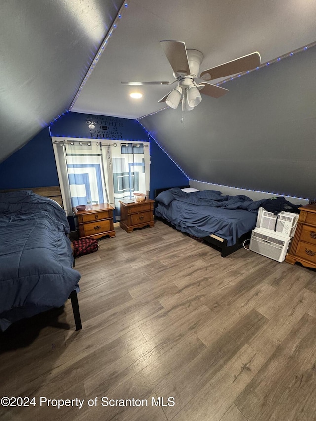 bedroom with ceiling fan, wood-type flooring, and lofted ceiling