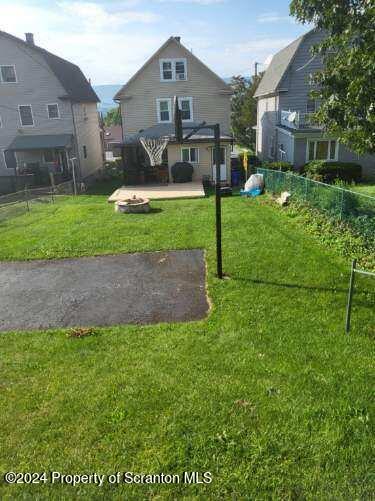 exterior space with a front yard and a patio