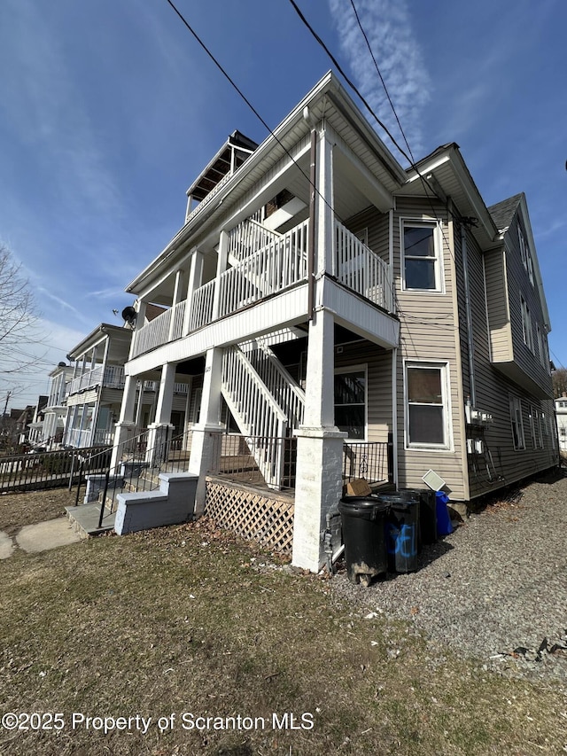 view of side of home with stairway