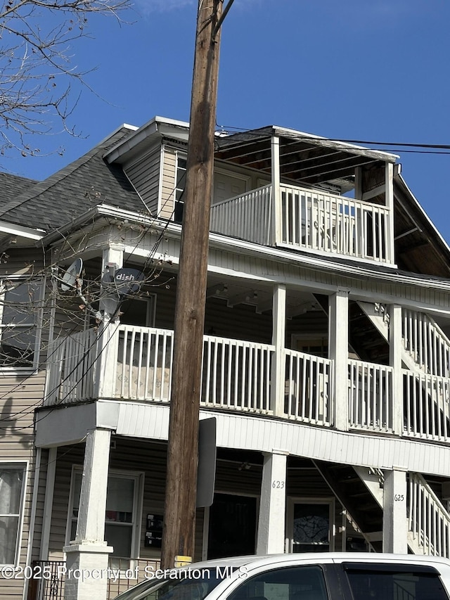 view of side of home featuring roof with shingles