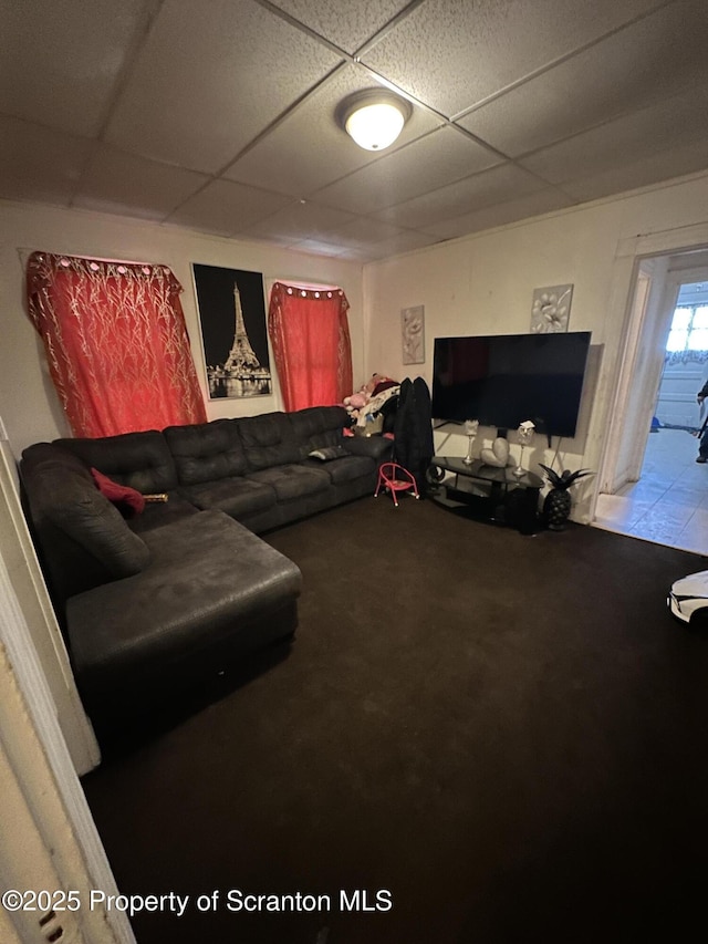 living room with a drop ceiling