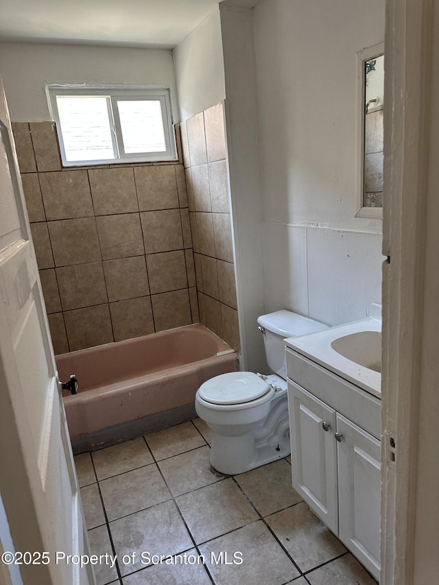 bathroom featuring tile patterned floors, shower / bathtub combination, toilet, and vanity