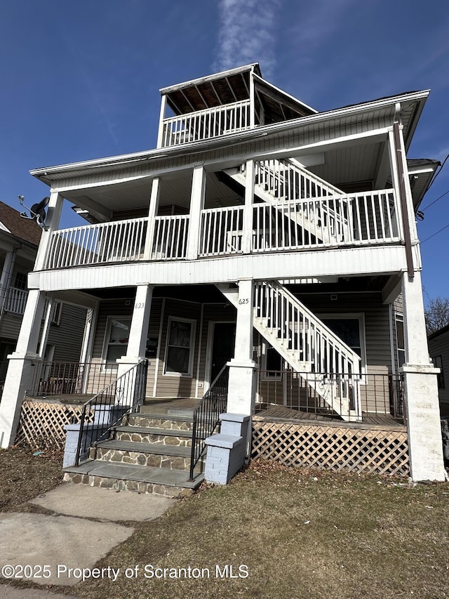 view of front of home with covered porch and stairs