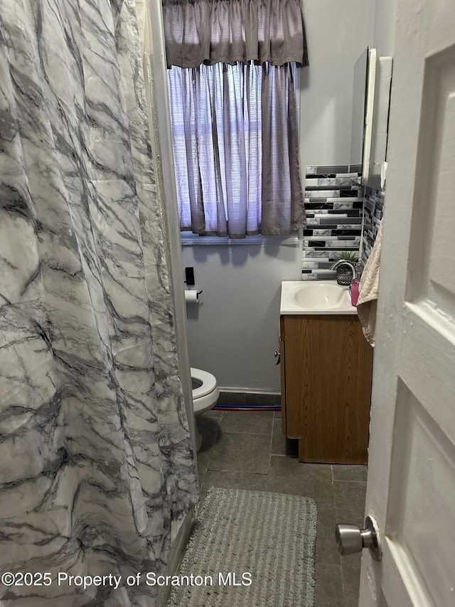 bathroom with toilet and vanity