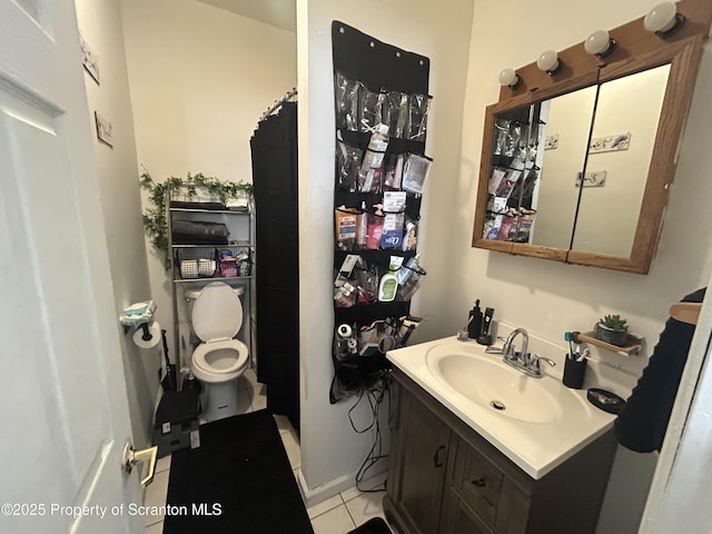 bathroom with vanity, toilet, and tile patterned flooring