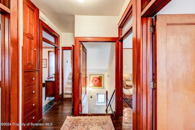 corridor with dark hardwood / wood-style flooring