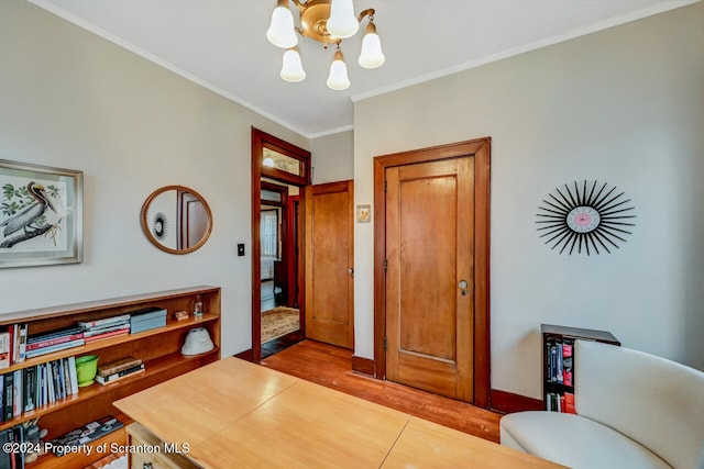 interior space with light tile patterned flooring, ornamental molding, and an inviting chandelier