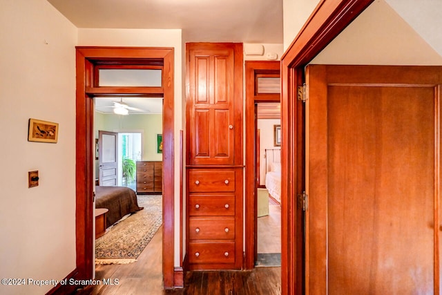 hall with hardwood / wood-style flooring