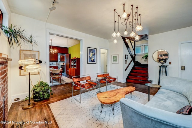 living room with hardwood / wood-style floors and an inviting chandelier