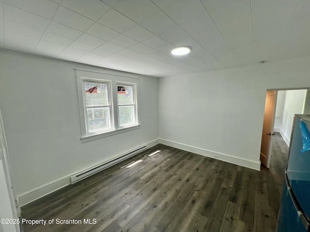 133-135 Newport St, Glen Lyon, PA 18617 - empty room with a baseboard heating unit and dark wood finished floors