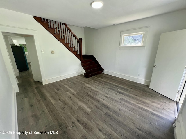 133-135 Newport St, Glen Lyon, PA 18617 - unfurnished living room featuring dark wood-style floors and stairway