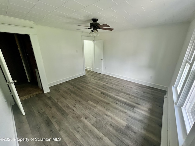 133-135 Newport St, Glen Lyon, PA 18617 - empty room featuring a ceiling fan, healthy amount of natural light, dark wood-type flooring, and a baseboard heating unit